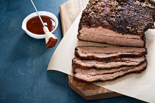 Sliced slowly cooked brisket with bbq sauce